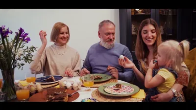 A family laughing around a breakfast table